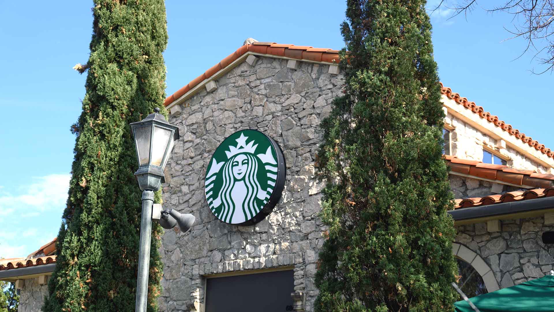 A close up look at a coffee house logo above a door on a stone building at Adriatica.